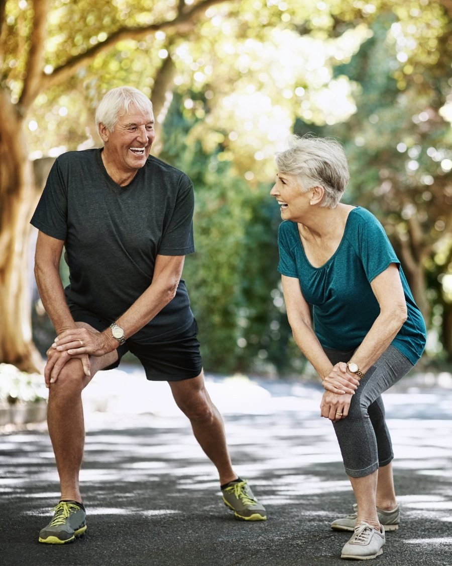 Active older couple stretching outdoors
